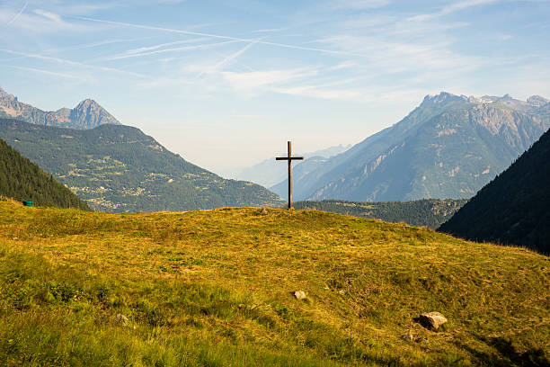 A view of a cross in a field in Switzerland. Photo taken while hiking on the Tour du Mont Blanc