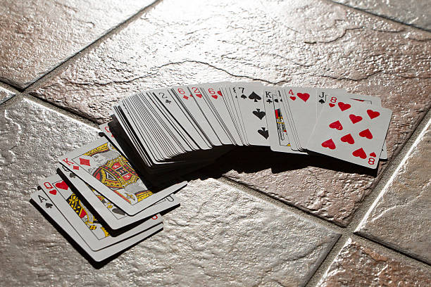 istock Playing cards scattered wildly across the floor, playing poker 2230136829