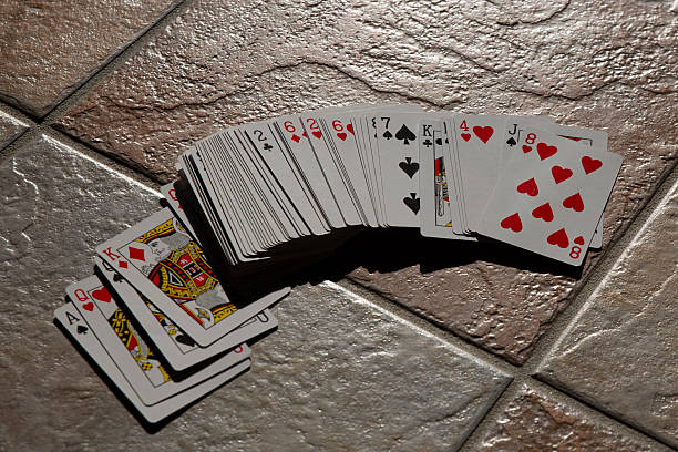 istock Playing cards scattered wildly across the floor, playing poker 2230136846