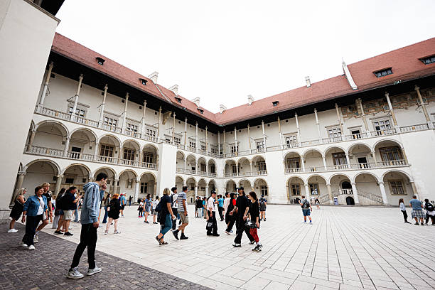 Krakow, Poland - July 08, 2025: A courtyard in Krakow, Poland, featuring historical architecture and tourists exploring.