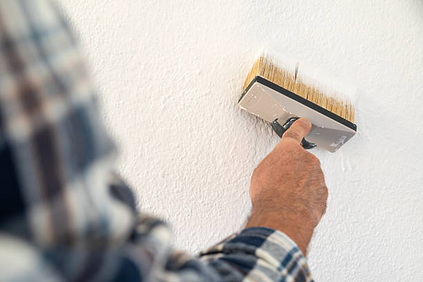 istock House painter worker painting a wall white. Building. 2230140683