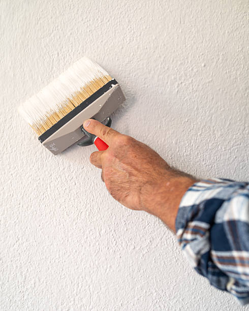 istock House painter worker painting a wall white. Building. 2230140796