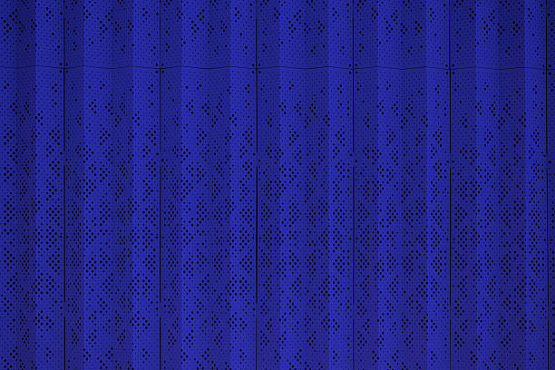 Blue perforated metal panels for enclosing technical units.\tModular perforated steel enclosure for utilities and equipment in urban public space. Construction background. Real photo
