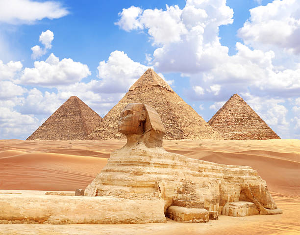 istock Famous Great Sphinx and pyramids of Menkaure, Chephren, Cheops, Cairo, Egypt. Three iconic Great Pyramids, Sphinx and sand dunes in Giza Necropolis, have become a popular destination for travellers 2230144946