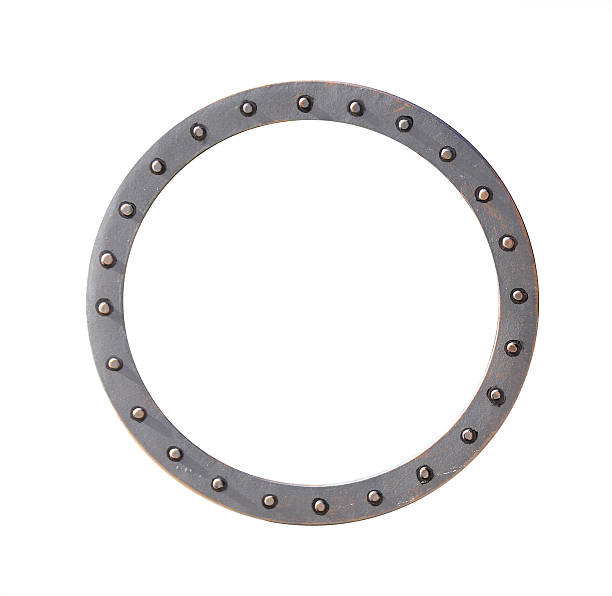 istock Metallic retro round frame with vintage rivets. Isolated on white background. Can be used for steampunk, mechanical design and industrial aesthetics. Vintage-inspired circular metal frame 2230145290
