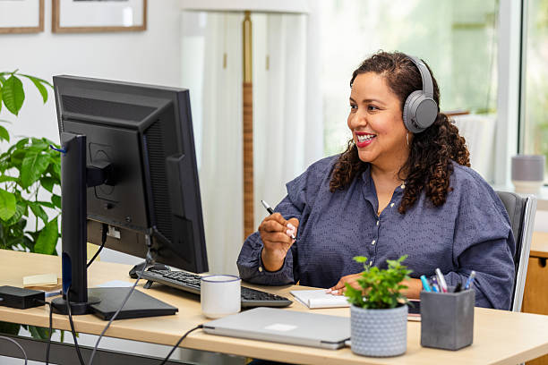istock Hispanic Woman Using Computer in Home Office, Video Call 2230145845