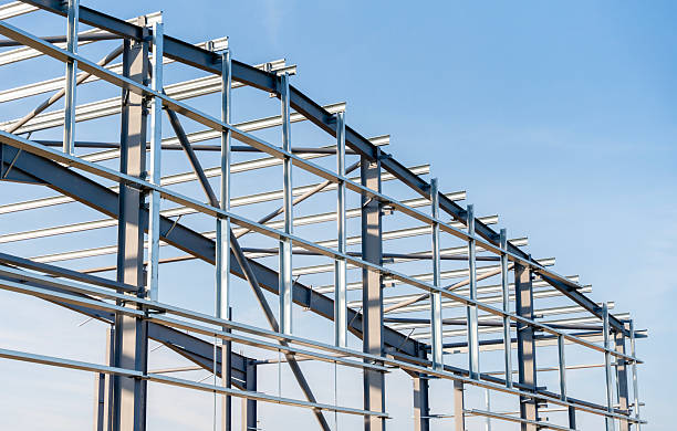 istock Steel frame building structure stands against blue sky 2230148244
