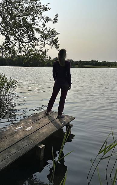 istock girl at sunset on the river 2230148508