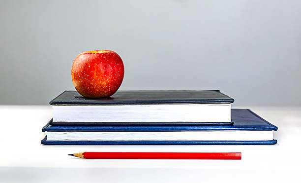 istock a notebook, a red pencil and an apple. concept education Back to shcool 2230148864