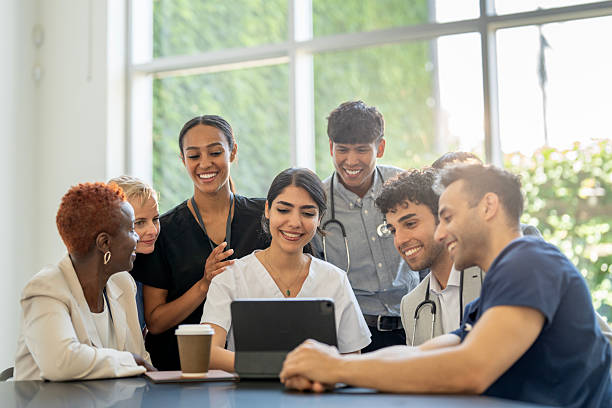 istock Diverse Medical Team Collaborating on a Digital Project in a Bright Room 2230152034