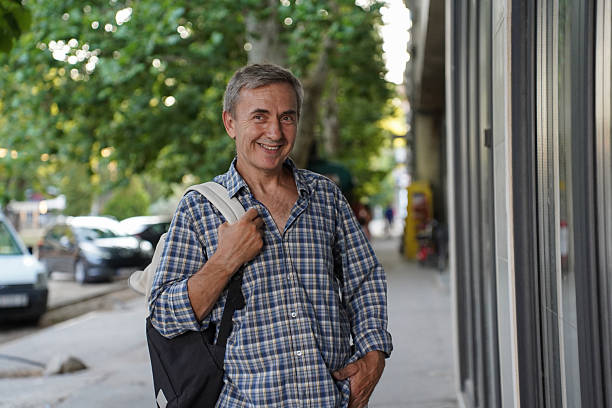 istock Senior man walking through city and window shopping 2230155450