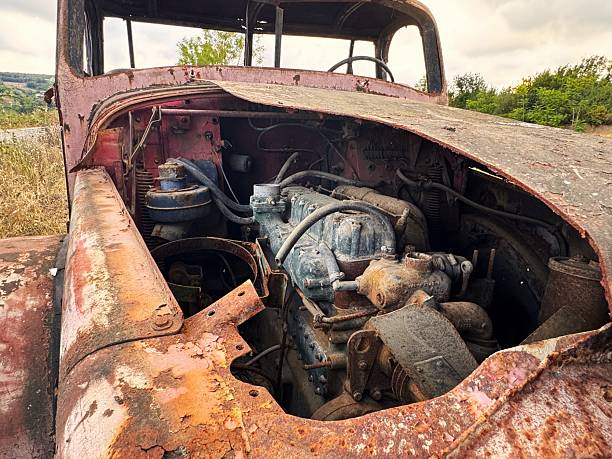istock An old and decayed car in a cloudy evening as the sun sets 2230157293