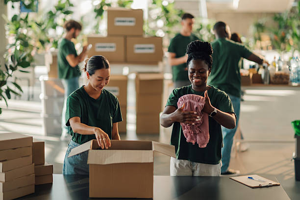 istock Volunteers preparing clothes donations in cardboard boxes 2230159407
