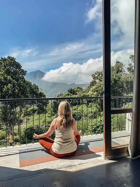 istock Middle-aged woman practicing yoga on a balcony 2230160403