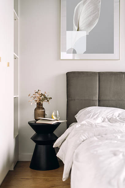 istock Cozy hotel suite bedroom featuring elegant decor and inviting bedding 2230160921