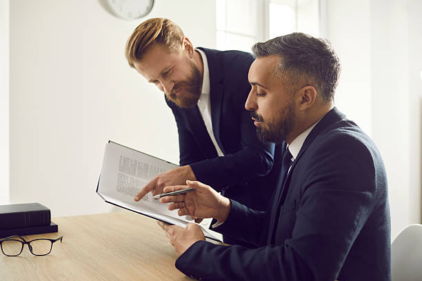 istock Diverse businessmen discuss paperwork or contract together 2230163203