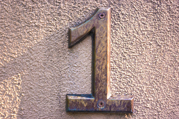 istock Sunlit Brass Number 1 Street Address, Beige Background 2230165893