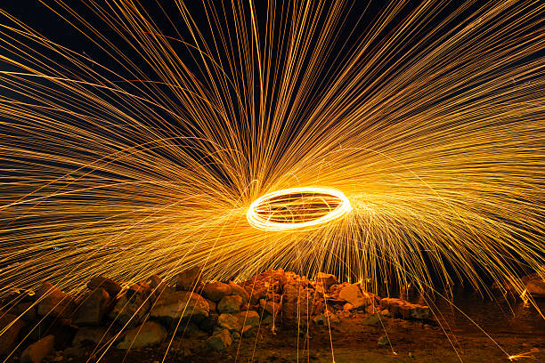 Fireworks, steel wool effect on the night sky.