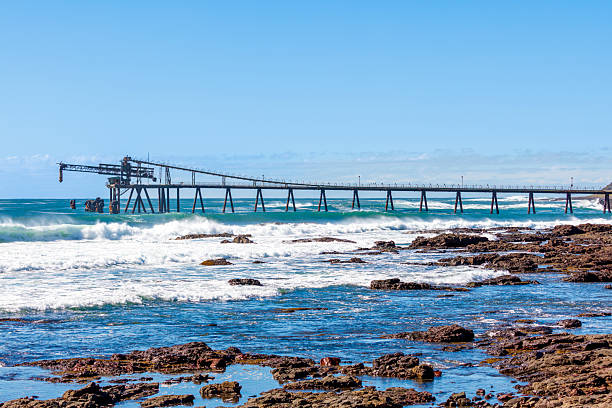 istock An old and weathered industrial loading jetty and crashing waves 2230170627