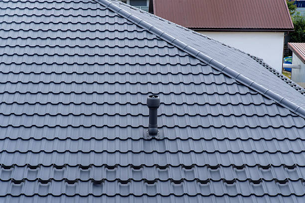 istock Plastic roof vent pipe on gray metal tile roofing 2230172359