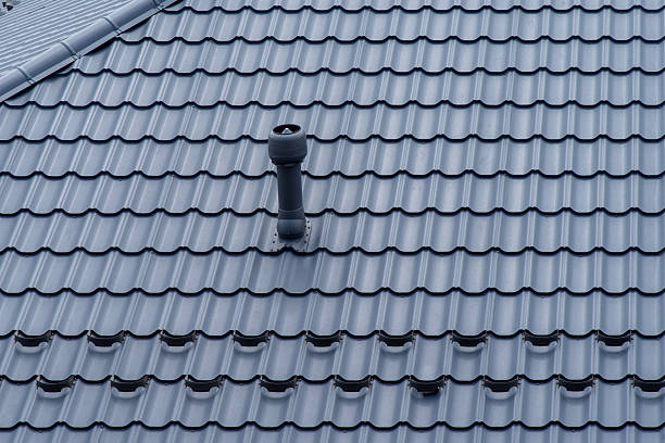 istock Plastic roof vent pipe on gray metal tile roofing 2230172362