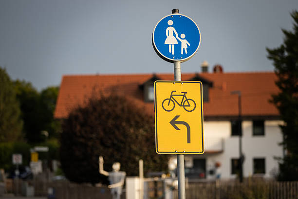 Bicycle and pedestrian walkway sing on the road.\nNeufarn - Germany.