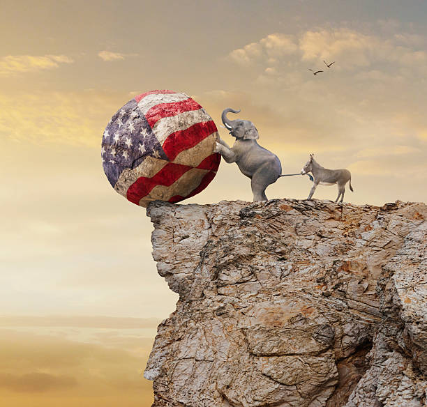 Conceptual image of elephant rolling American flag off of cliff and donkey pulling elephants tail