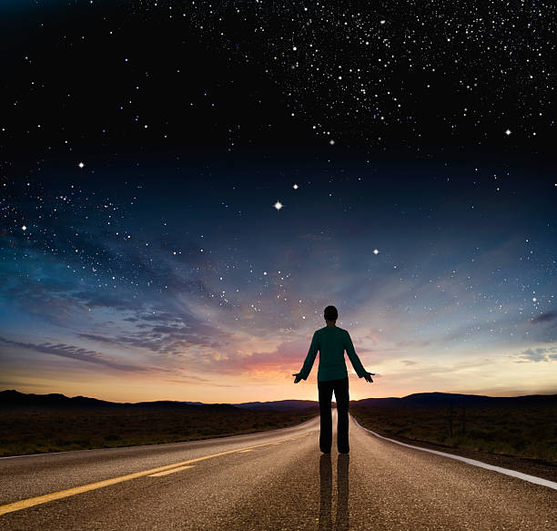 istock Conceptual image of man standing on empty road at twilight 2230173214