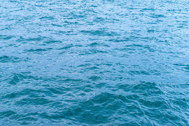 Tranquil blue sea with soft ripples and sunlight reflections, ideal for nature, summer, or peaceful vacation themes