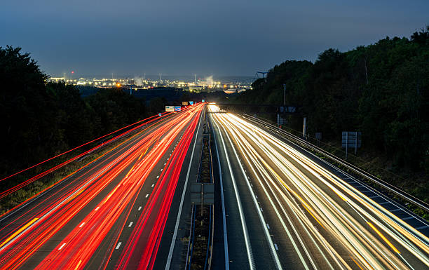 istock Light trails illuminating highway at dusk, showcasing dynamic transportation network 2230176091