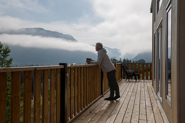 istock Mature man enjoys hot beverage on cabin deck 2230179399