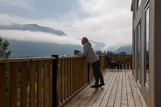 istock Mature man enjoys hot beverage on cabin deck 2230179412