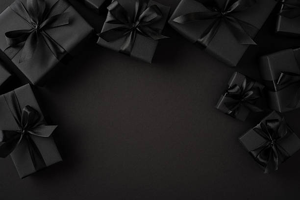istock A collection of classy black gift boxes with ribbons and bows arranged alongside a dark backdrop, offering a sophisticated aesthetic suitable for celebrations, events, or promotional themes 2230179516