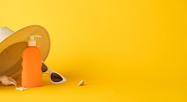 istock Sunny summertime items including sunscreen bottle, straw hat, and sunglasses against a vibrant yellow background creating a cheerful outdoor vacation feel 2230179519