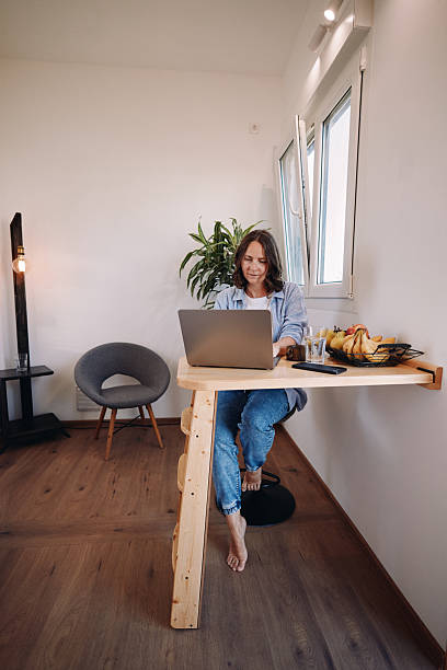 istock Woman Working from Home in a Tiny House – Minimal, Focused Workspace 2230181336