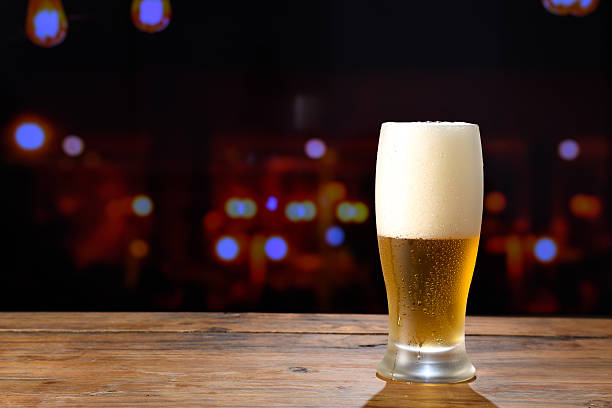 istock Refreshing beer on a wooden table in a bar 2230181428