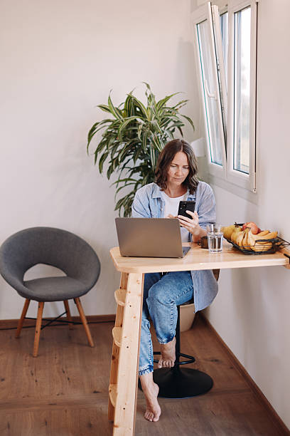 istock Woman Working from Home in a Tiny House – Minimal, Focused Workspace 2230182130