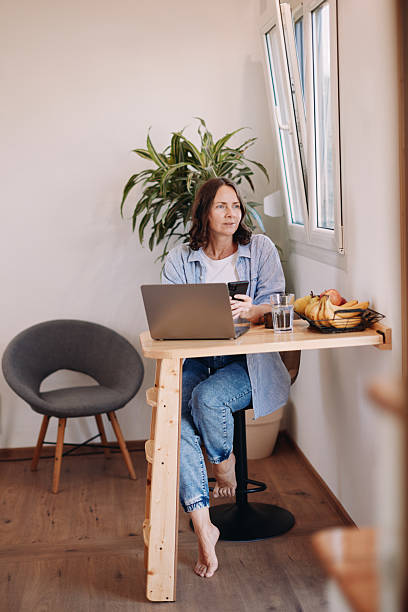 istock Woman Working from Home in a Tiny House – Minimal, Focused Workspace 2230182897