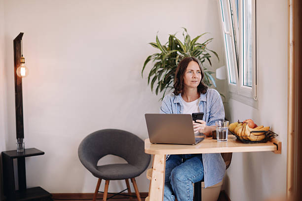 istock Woman Working from Home in a Tiny House – Minimal, Focused Workspace 2230183076