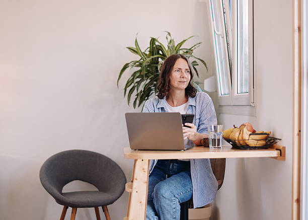 istock Woman Working from Home in a Tiny House – Minimal, Focused Workspace 2230183274