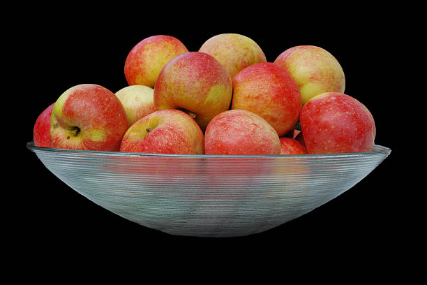 Whole green apples in the stainless steel kitchen bowl on a gray background
