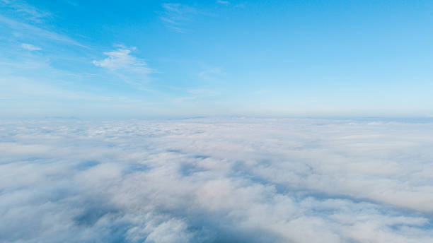 istock Aerial View of Fluffy White Clouds Against Clear Blue Sky 2230187326