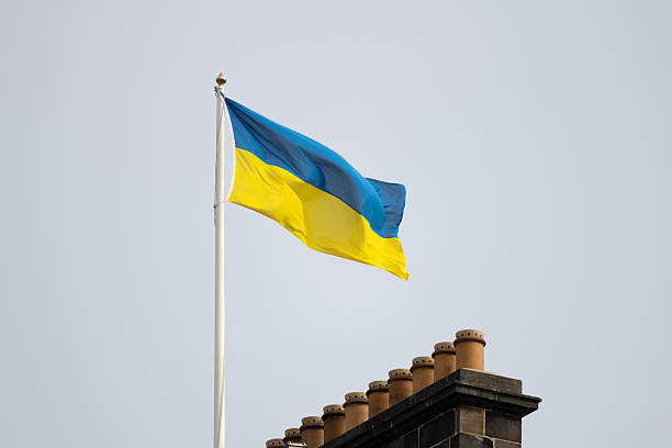 istock Flag with a blue and yellow stripe is flying high in the sky 2230188255