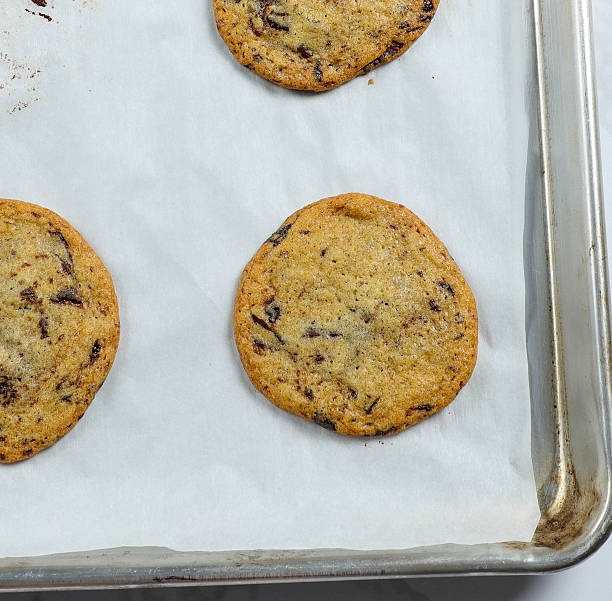 Chocolate Chip Cookies on a Baking Sheet with White Parchment Paper