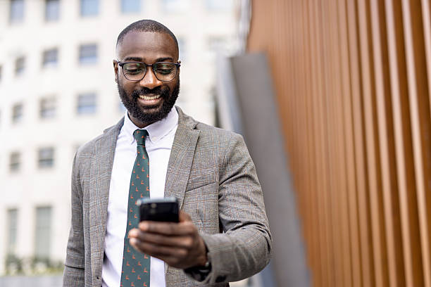 istock Man Checking His Phone While Smiling, Stylish Outfit 2230204683