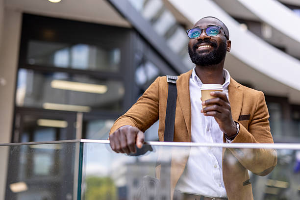istock Smiling Man with Coffee and Tablet in Urban Setting Outdoors 2230204719