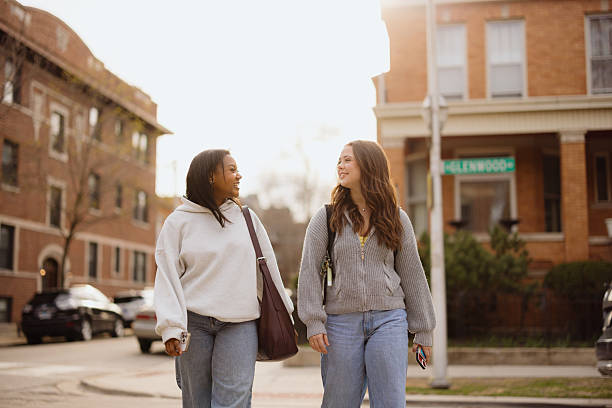 istock Two young female students walking and talking on campus 2230204879