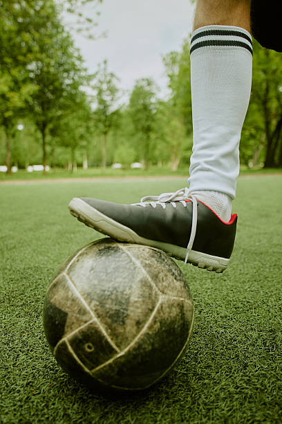 istock Boy Balancing Soccer Ball on Field during Outdoor Training 2230206512