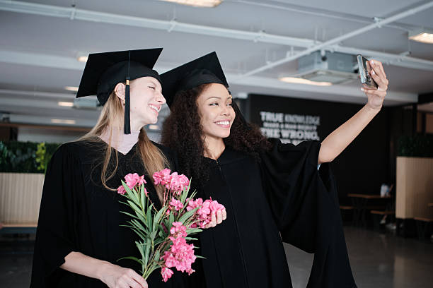 istock Two diverse female graduate students take a selfie with mobile phone together. 2230206791