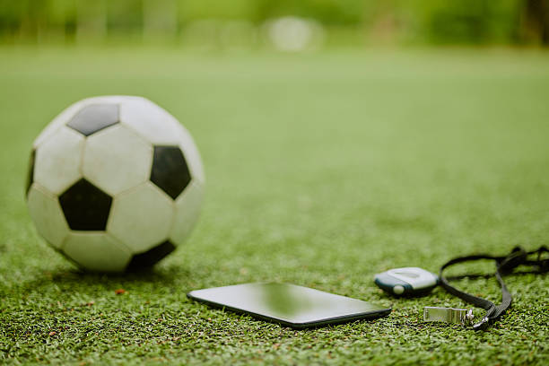 istock Soccer Ball and Digital Tablet Lying on Grass during Outdoor Training Session 2230206810